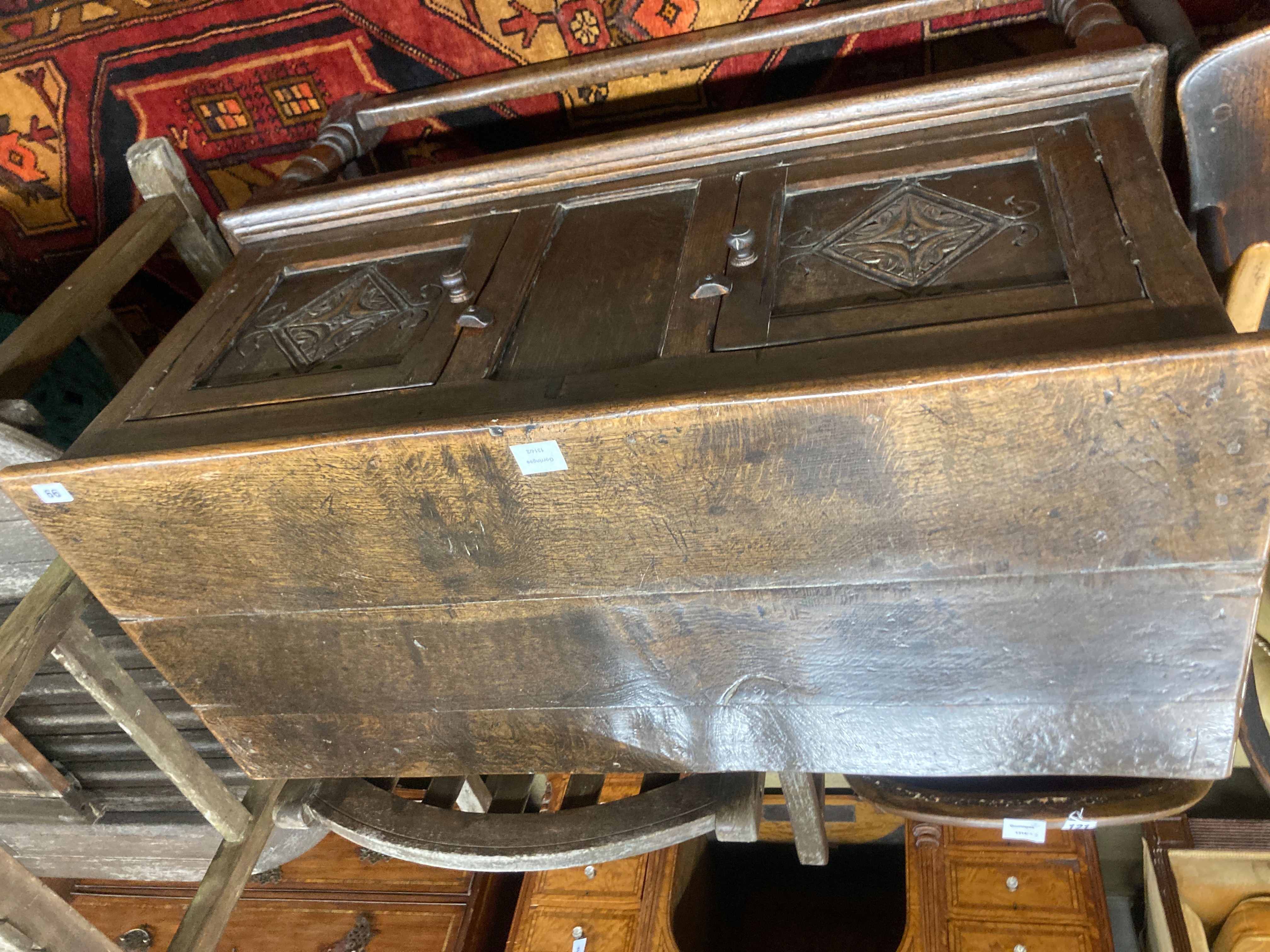 A Tudor style oak two door cupboard, enclosed by two doors, width 108cm, depth 50cm, height 88cm